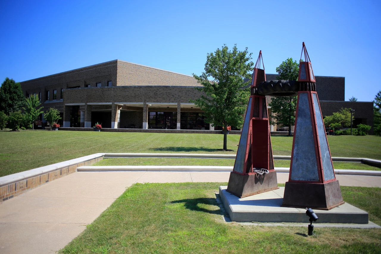 Large public sculpture with IU East campus building in the background