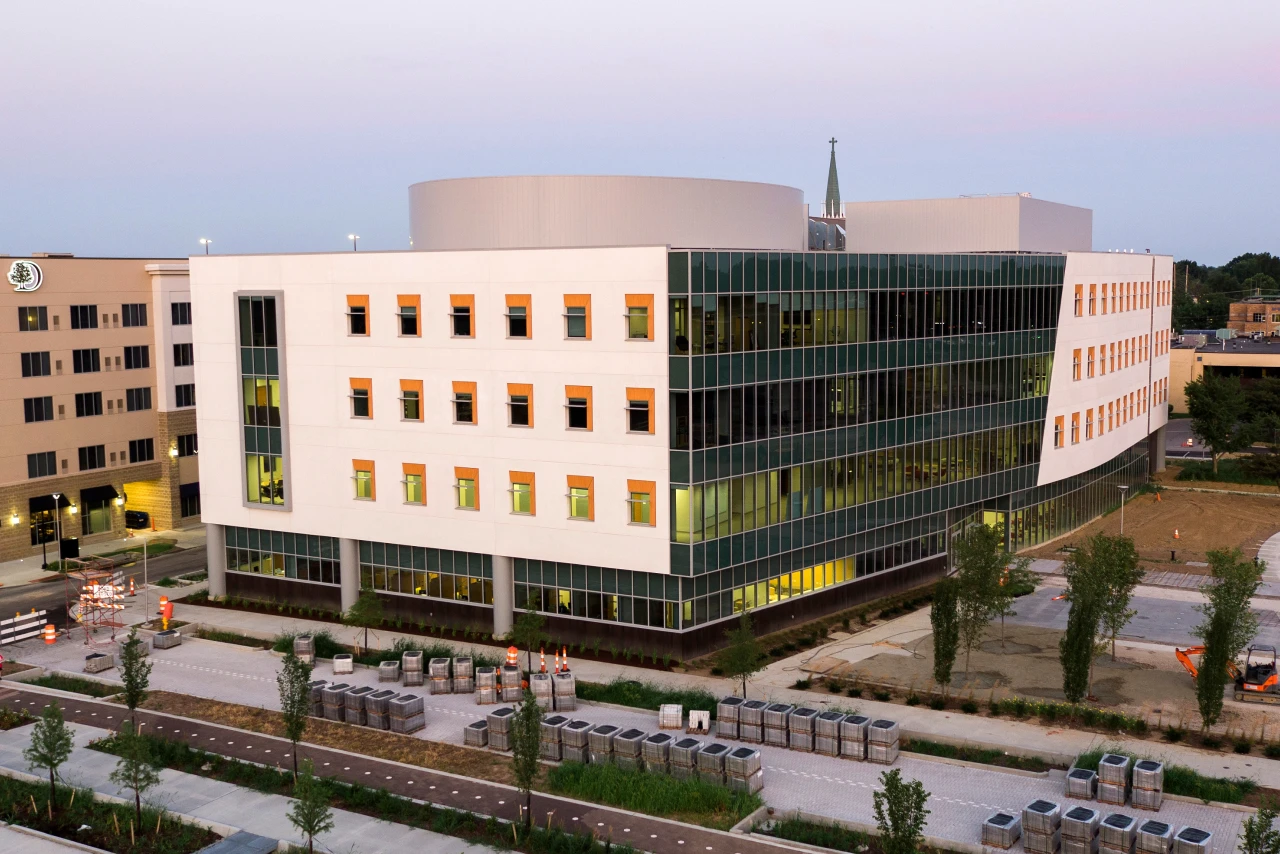 Aerial photo of a four story School of Medicine building with a white and glass exterior